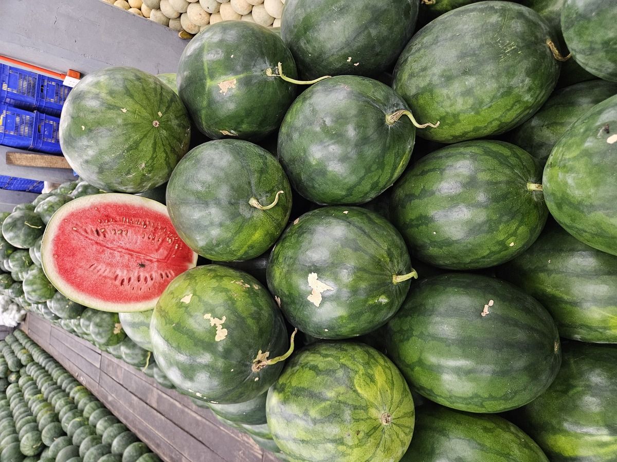 Pile of seedless watermelons with one cut open in Quezon City