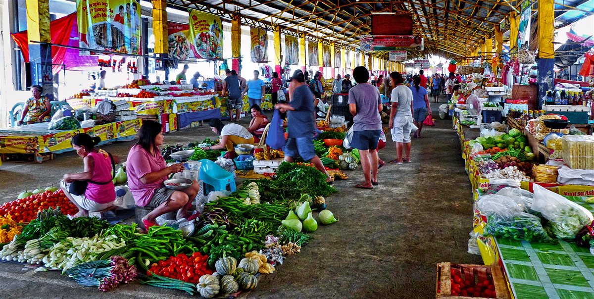 Shoppers and vendors at the Batac City public market in Ilocos Norte with fresh local vegetables